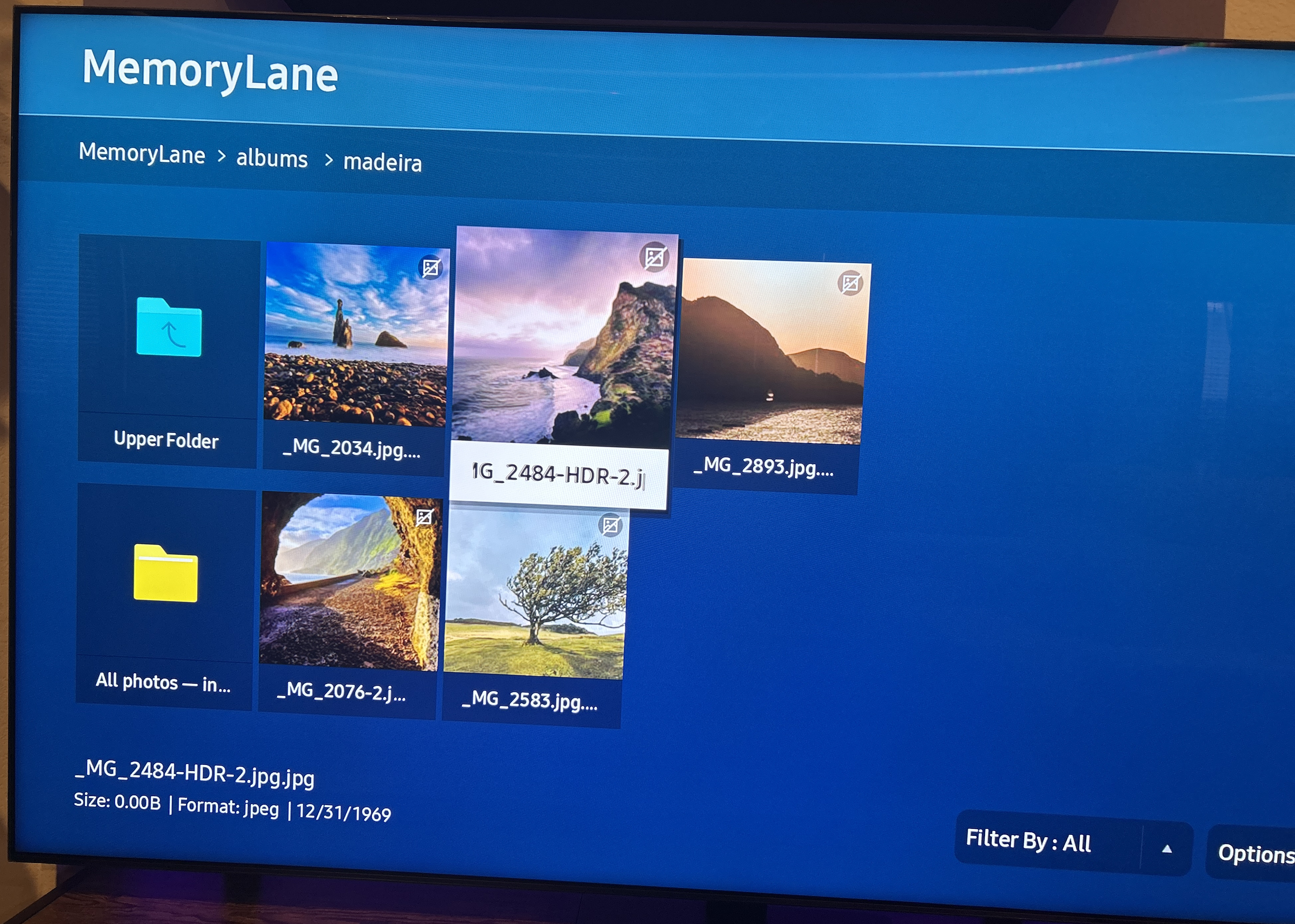 A smart TV browsing a MemoryLane photo collection over DLNA on the local network